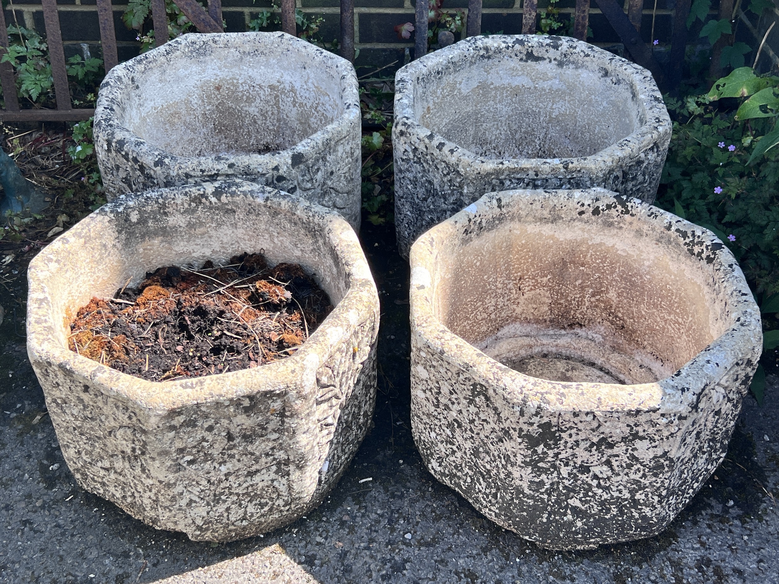 A set of four reconstituted stone hexagonal garden planters, width 40cm, height 29cm